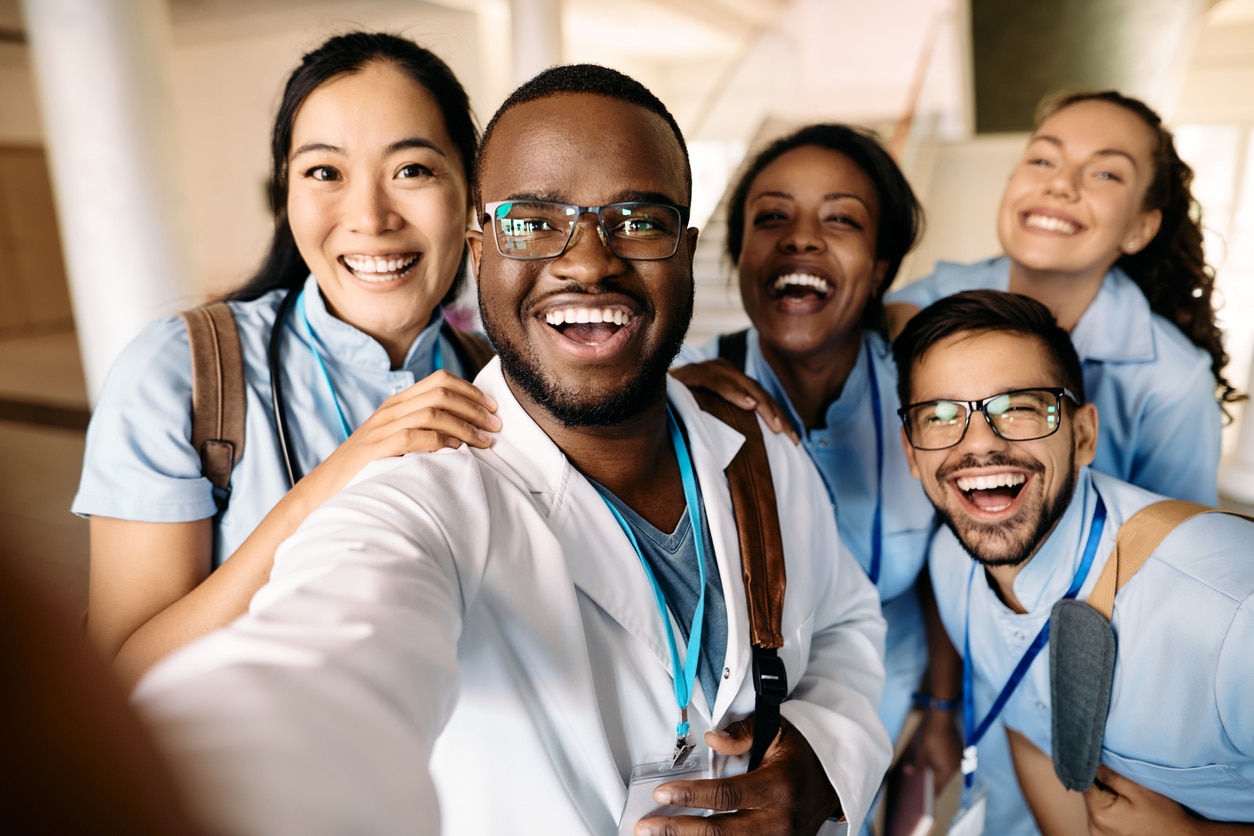 Multi-ethnic group of happy students having fun wile taking selfie at medical university.